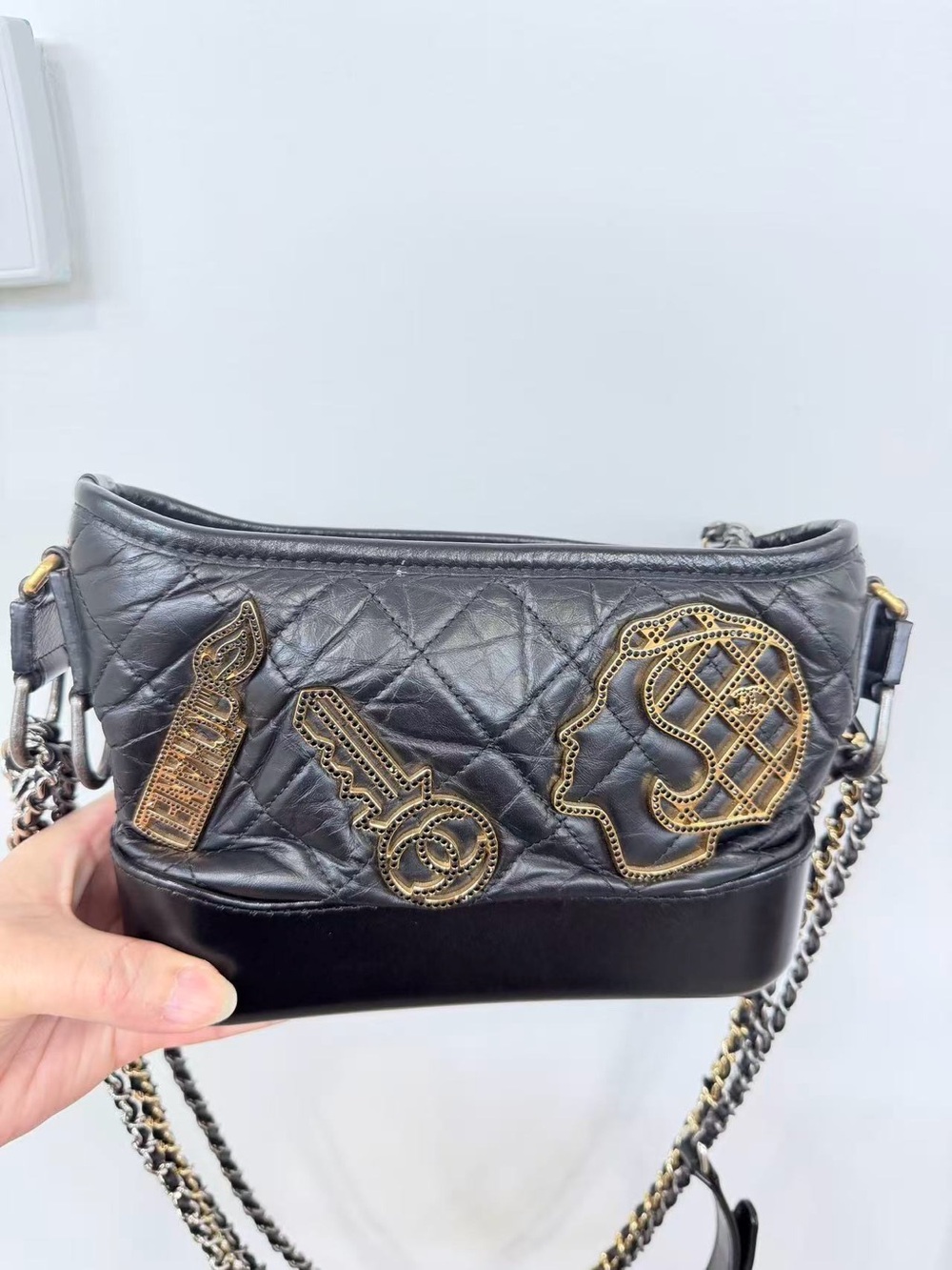 CHANEL Black Quilted Leather Crossbody Bag with Gold Patch Accents